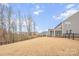 Large backyard with sloped terrain, providing privacy and space at 800 Landau Rd, Waxhaw, NC 28173