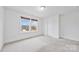 Bright bedroom with neutral carpeting and large window at 800 Landau Rd, Waxhaw, NC 28173