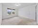 Bright bedroom with neutral carpeting and large window at 800 Landau Rd, Waxhaw, NC 28173