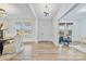 Light-filled entryway with hardwood floors, showcasing access to various rooms at 800 Landau Rd, Waxhaw, NC 28173