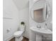 Clean powder room with pedestal sink and round mirror at 800 Landau Rd, Waxhaw, NC 28173