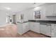 Kitchen features white cabinets, granite countertops, and a view of the living room at 9232 Sardis Forest Dr, Charlotte, NC 28270