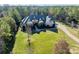 An elevated view of an expansive estate with lush landscaping and a long winding drive at 9809 Saddle Ave, Waxhaw, NC 28173