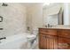 Bathroom with tub, granite vanity, and tile shower surround at 9809 Saddle Ave, Waxhaw, NC 28173