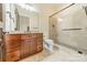 Bathroom features a granite-topped vanity, a glass-enclosed shower, and neutral tiling for a modern aesthetic at 9809 Saddle Ave, Waxhaw, NC 28173