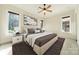 Well-lit bedroom with multiple windows, neutral walls, and a modern patterned rug creating a cozy space at 9809 Saddle Ave, Waxhaw, NC 28173
