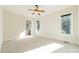 Bright bedroom with carpet flooring, ceiling fan, and two large windows at 9809 Saddle Ave, Waxhaw, NC 28173