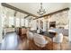 Dining area showcasing hardwood floors, wood beams, and view of the kitchen and great room at 9809 Saddle Ave, Waxhaw, NC 28173