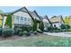 Charming exterior with stone accents, lush greenery, and meticulously landscaped front yard at 9809 Saddle Ave, Waxhaw, NC 28173