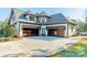 Three-car garage with carriage doors and spacious driveway at 9809 Saddle Ave, Waxhaw, NC 28173