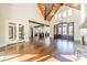 Spacious great room featuring hardwood floors, wood beams, and a stone fireplace at 9809 Saddle Ave, Waxhaw, NC 28173