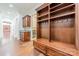 Mudroom with wood floors, custom built-ins, hooks, shelving, and granite countertop in a convenient space at 9809 Saddle Ave, Waxhaw, NC 28173