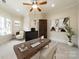 Well-lit office with a large wooden desk, neutral walls, and a comfortable seating area, ideal for productivity at 9809 Saddle Ave, Waxhaw, NC 28173