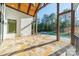 Covered patio with stone flooring that leads to a sparkling pool, ideal for entertaining at 9809 Saddle Ave, Waxhaw, NC 28173