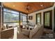 Cozy screened porch with comfortable seating, wooden ceiling, and views of the landscaped backyard at 9809 Saddle Ave, Waxhaw, NC 28173