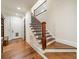Elegant staircase with hardwood steps and detailed wrought iron railings leading to the upper level at 9809 Saddle Ave, Waxhaw, NC 28173