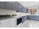 Modern laundry room with gray cabinets and patterned floor at 1021 Three Lakes Trl, Waxhaw, NC 28173