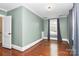 Light green painted bedroom with hardwood floors and window at 106 Patrick St, Gastonia, NC 28054