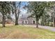 Landscaped yard with driveway leading to brick house at 106 Patrick St, Gastonia, NC 28054