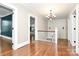 Upper hallway with hardwood floors, chandelier, and views to lower level at 106 Patrick St, Gastonia, NC 28054