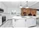 Kitchen boasts an island, brick fireplace, and stainless steel appliances at 106 Patrick St, Gastonia, NC 28054