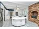 Eat-in kitchen with island, stainless steel appliances, and brick fireplace at 106 Patrick St, Gastonia, NC 28054