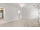 Well-lit bedroom with carpet, ceiling fan, and adjacent bathroom access at 10843 Alexander Mill Dr, Charlotte, NC 28277