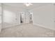 Bedroom with carpet, double doors to bathroom and hallway access at 10843 Alexander Mill Dr, Charlotte, NC 28277