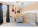 Bedroom featuring a crib, rocker, and guitar-themed decor at 126 Easy St, Mooresville, NC 28117