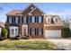 Brick two-story house with a large driveway and attached garage at 126 Easy St, Mooresville, NC 28117