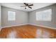 Bright bedroom with hardwood floors and two windows at 126 Oakley Dr, Harrisburg, NC 28075