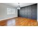 Modern dining room features hardwood floors and a dark gray accent wall at 126 Oakley Dr, Harrisburg, NC 28075