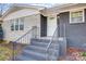 Steps leading to front door with metal railing at 126 Oakley Dr, Harrisburg, NC 28075