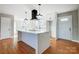 Modern kitchen with white cabinets and island at 126 Oakley Dr, Harrisburg, NC 28075