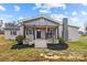 Gray brick ranch house with a front porch, rocking chairs, and landscaping at 1278 Burrell Rd, Clover, SC 29710