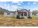 Gray brick ranch house with a front porch, rocking chairs, and landscaping at 1278 Burrell Rd, Clover, SC 29710