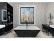 Elegant bathroom with a freestanding tub, modern tile, and a large window at 15650 Youngblood Rd, Charlotte, NC 28278
