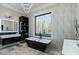 Spa-like bathroom featuring a freestanding tub, dual sinks, and large window at 15650 Youngblood Rd, Charlotte, NC 28278