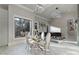 Elegant dining area with glass table, modern chairs, and large windows at 15650 Youngblood Rd, Charlotte, NC 28278