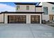 Modern two-car garage with glass paneled doors at 15650 Youngblood Rd, Charlotte, NC 28278