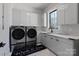 Modern laundry room with washer and dryer at 15650 Youngblood Rd, Charlotte, NC 28278