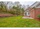 Brick home with a spacious backyard, patio, and sunroom at 158 Tetbury Ne Ave, Concord, NC 28025