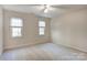 Bright bedroom featuring two windows with blinds and carpet floors at 158 Tetbury Ne Ave, Concord, NC 28025