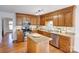 Kitchen boasts an island, ample wood cabinets, and stainless steel appliances at 158 Tetbury Ne Ave, Concord, NC 28025