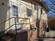 Backyard view of a two-story home with brick foundation and exterior access at 1608 Carfax Dr, Charlotte, NC 28216