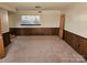 Spacious unfinished basement with a large window, paneled walls, and ample storage space, ready for customization at 1608 Carfax Dr, Charlotte, NC 28216