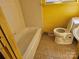 Compact bathroom with white fixtures and tile flooring at 1608 Carfax Dr, Charlotte, NC 28216