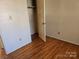 Modest bedroom features hardwood floors, a closet, and neutral colored walls at 1608 Carfax Dr, Charlotte, NC 28216
