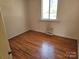 Bright bedroom with hardwood floors, a window, and a neutral color scheme at 1608 Carfax Dr, Charlotte, NC 28216