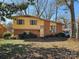 Charming front exterior featuring brick facade, mature trees, and a well-maintained lawn on a sunny day at 1608 Carfax Dr, Charlotte, NC 28216